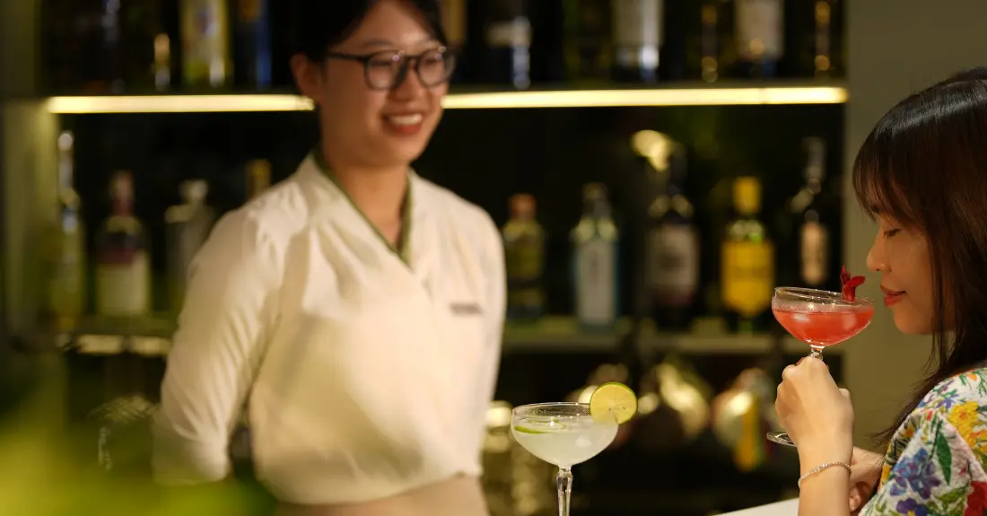 lady enjoying cocktails greenfield dental hanoi where in vietnam