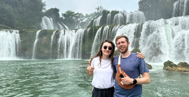 travelers at waterfall chom chom travel