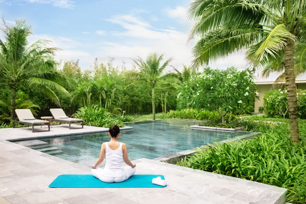 woman doing yoga at the pool maia resort quy nhon where in vietnam